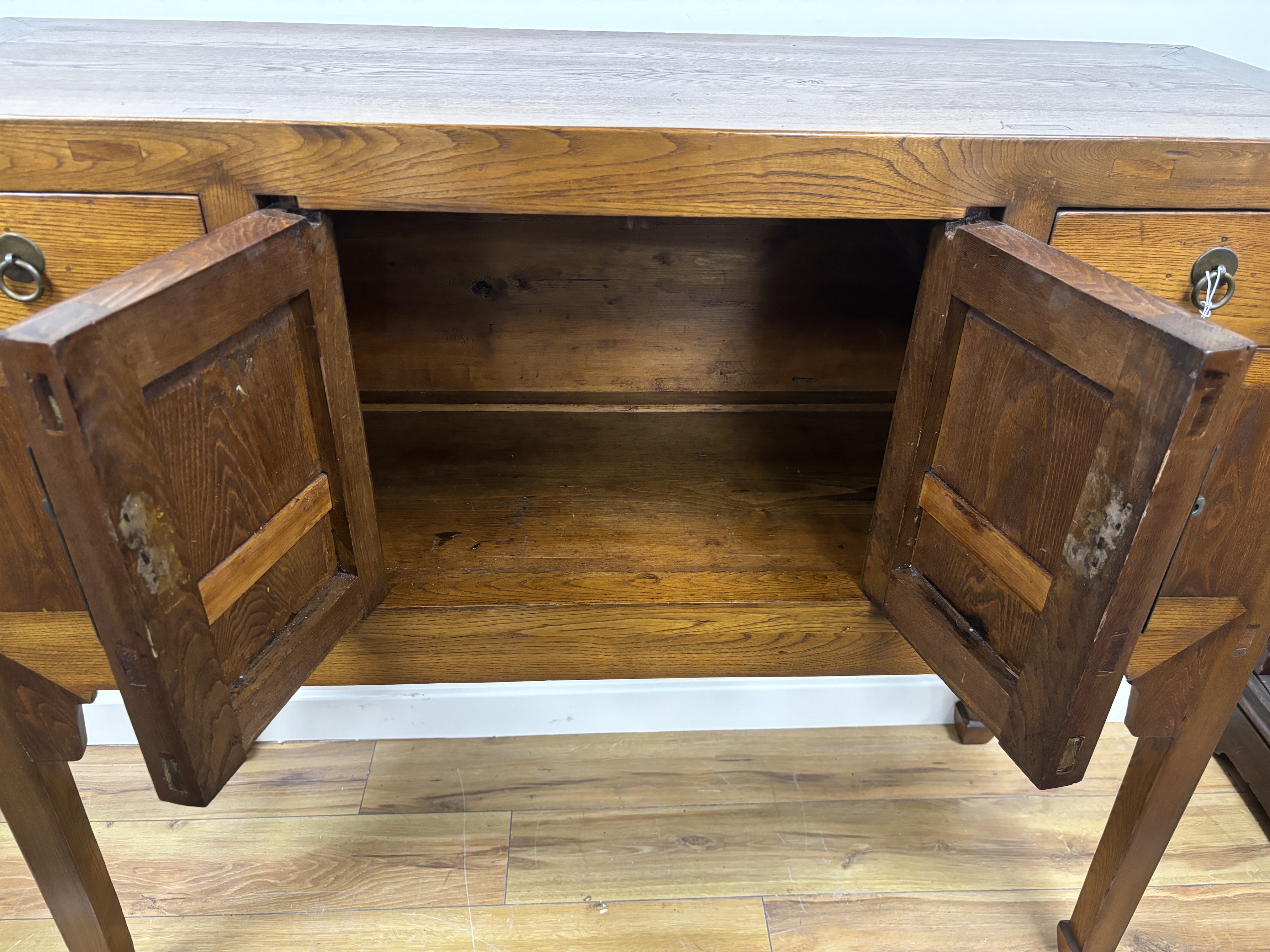 A Chinese elm jumu cabinet, width 128cm, depth 44cm, height 107cm